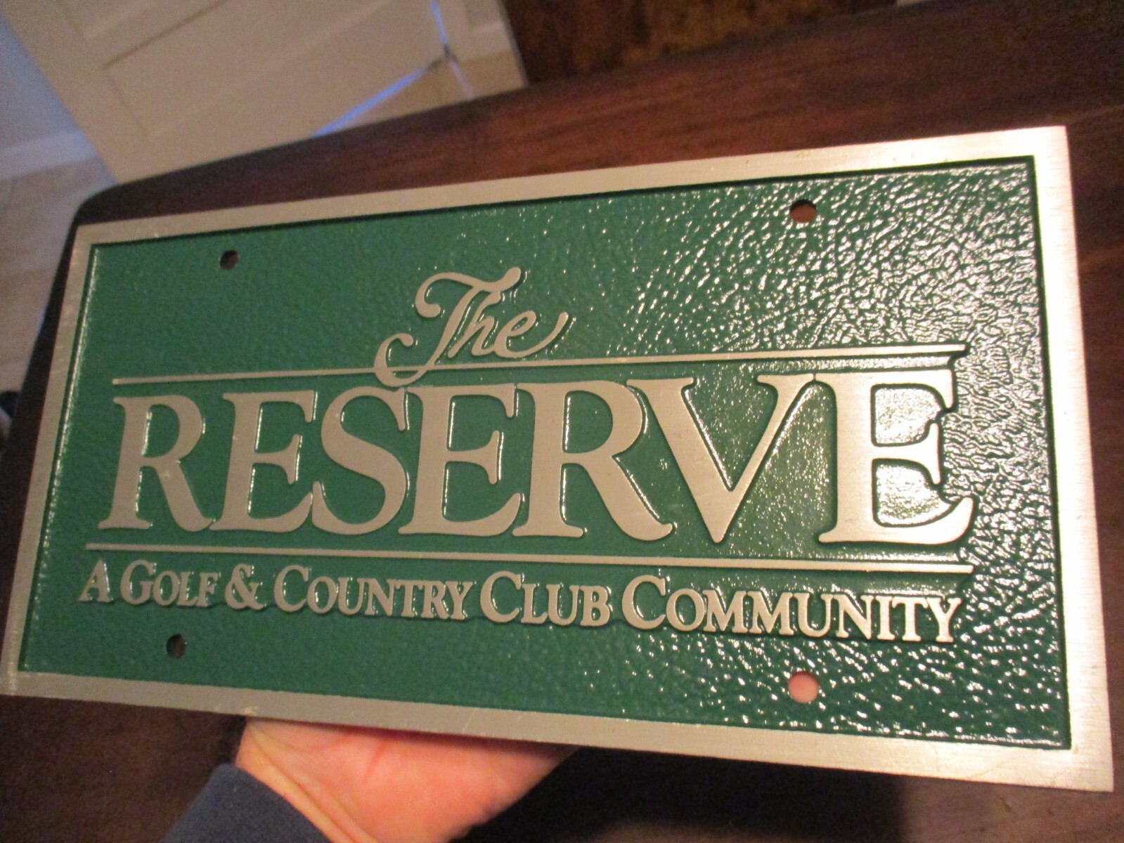 The RESERVE A Golf & Club Community embossed solid aluminum golf course sign