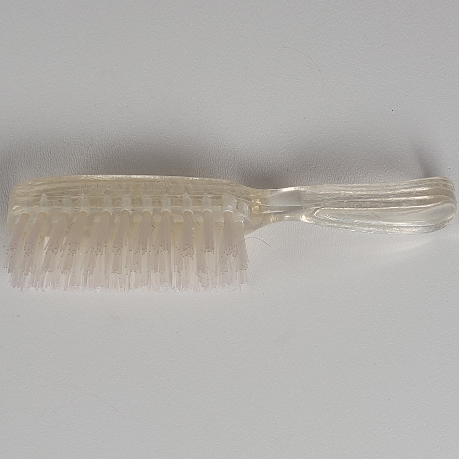 vintage-style hair care set containing a hairbrush, a smaller hand or nail brush