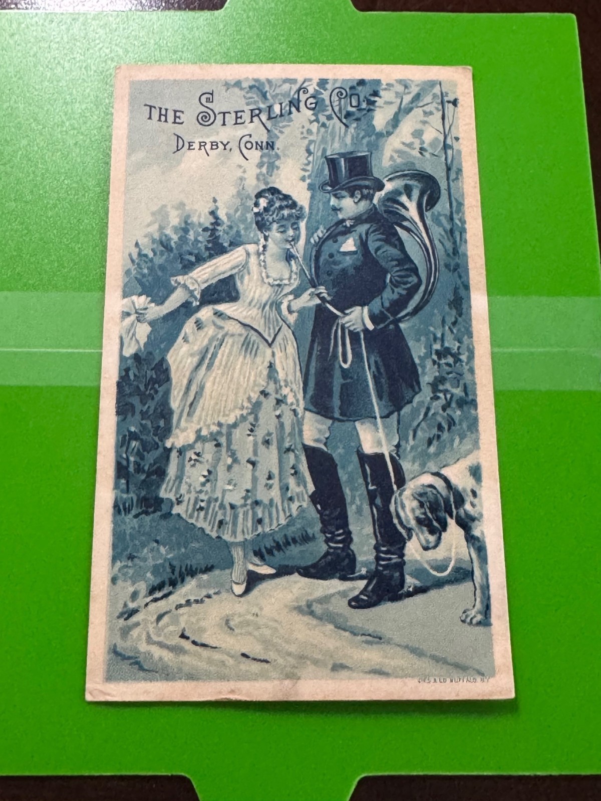 E-089 – Victorian Trade Card – The Sterling Co. – Woman Blowing Man’s Horn
