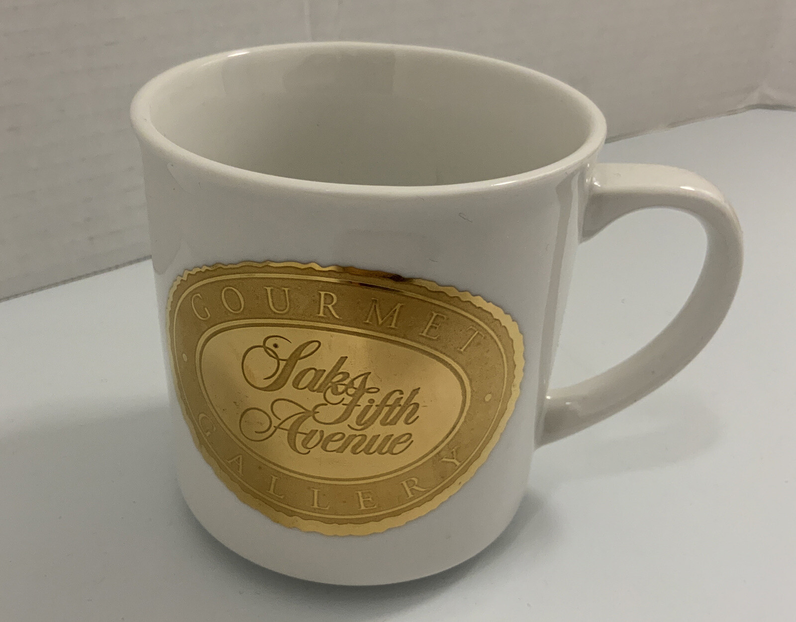SAKS Fifth Avenue Porcelain Coffee Mug Gourmet Gallery Gold Flake Emblem