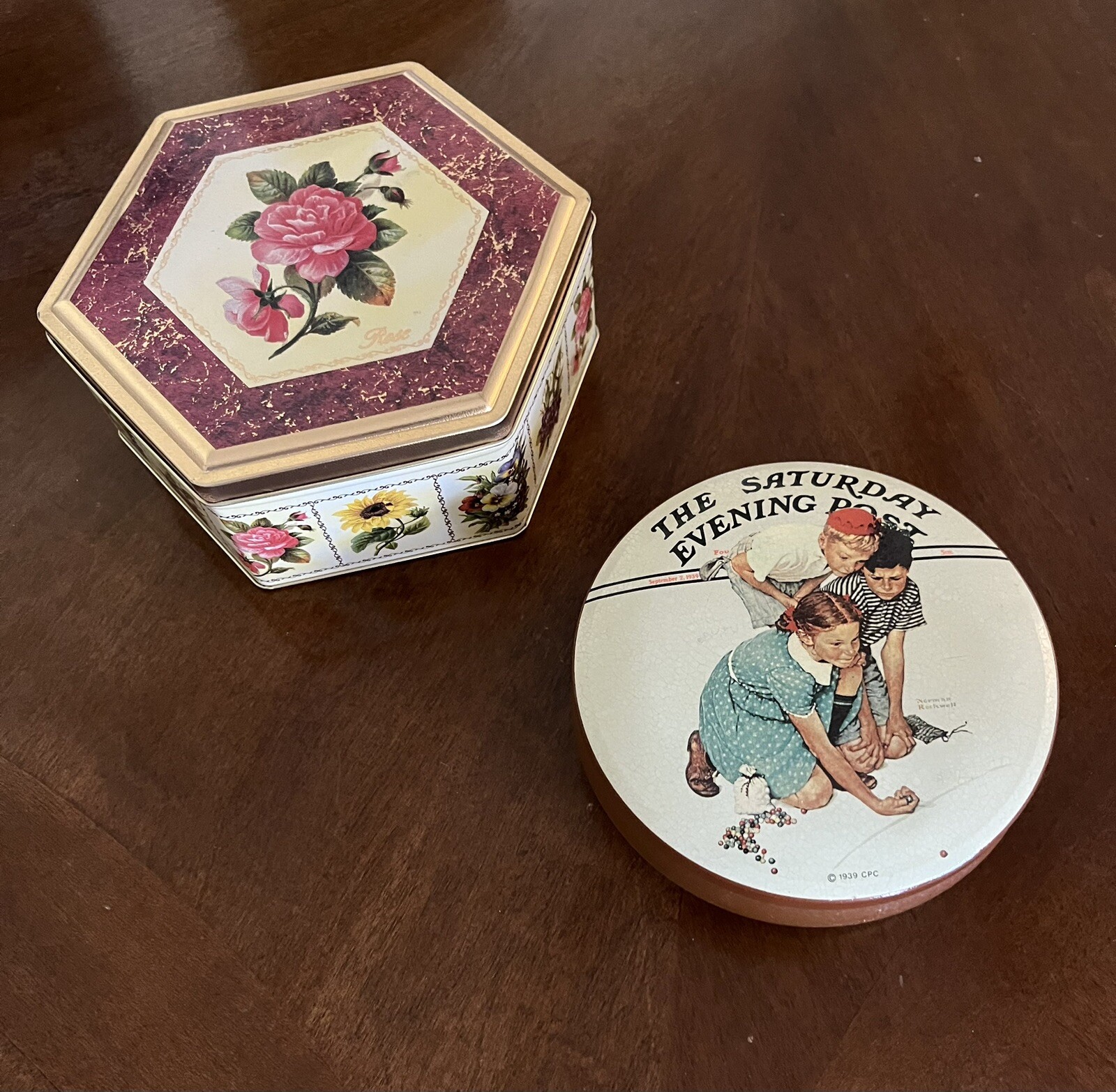 2 vtg tins-Six Sided Floral w/Roses 2.5×7″ & Round Norman Rockwell Marbles Champ