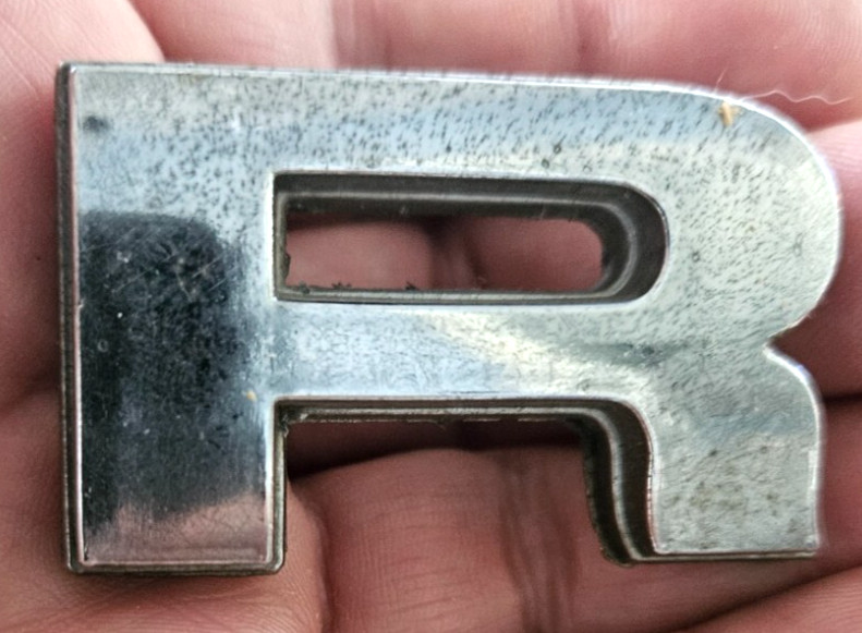 Metal Chrome “R” advertisement Logo Piece 2 x 1.25″ affix to your favorite item
