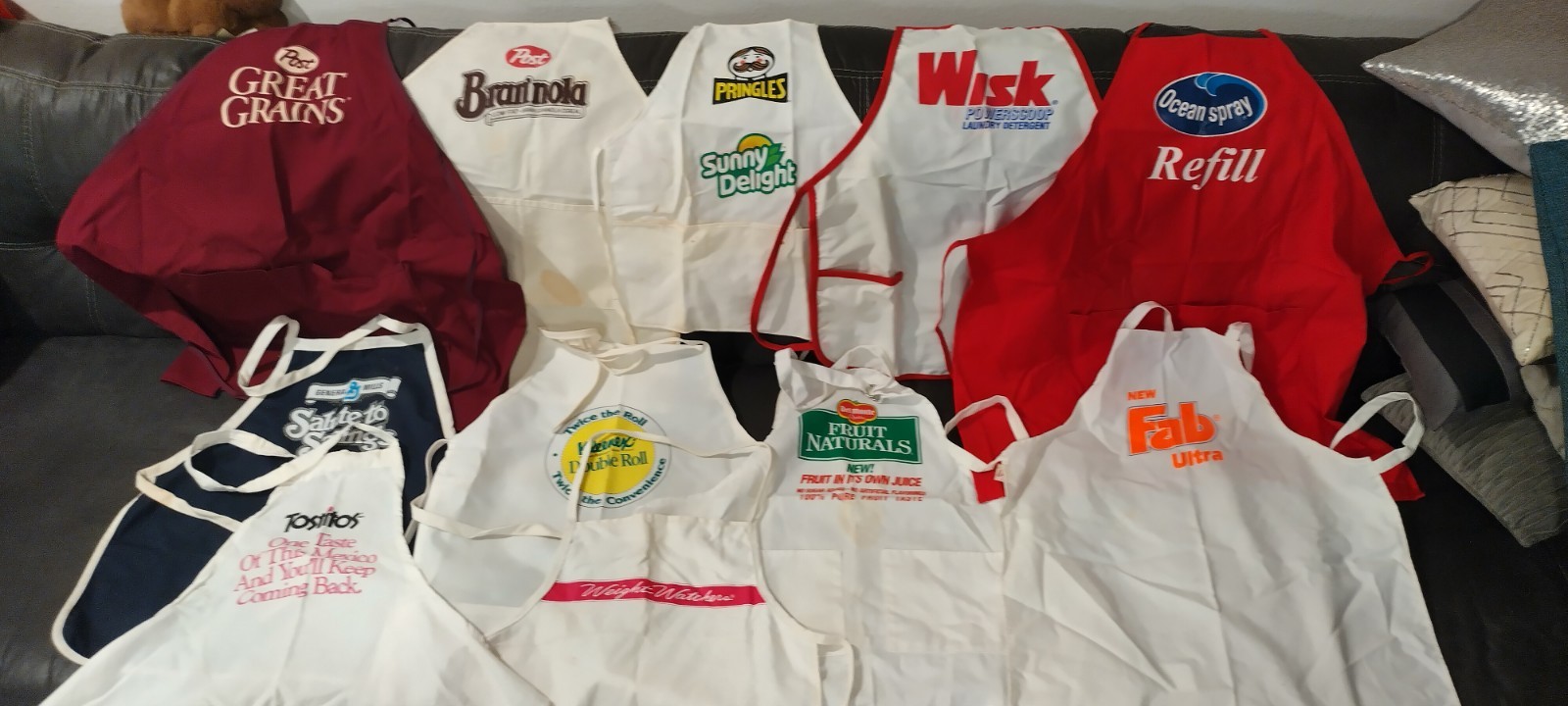 VINTAGE LOT OF 11 ADVERTISING APRONS, POST, FAB,WISK PRINGLES, SUNNY DELIGHT +