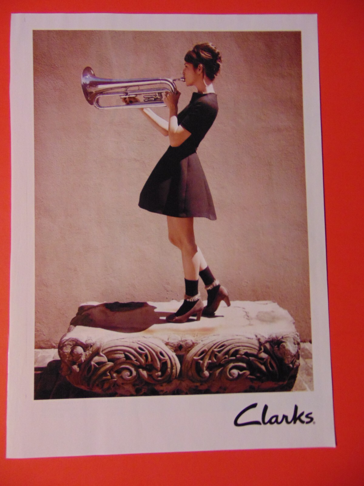 2011 CLARKS Fashion Woman Plays Big Horn photo art print ad