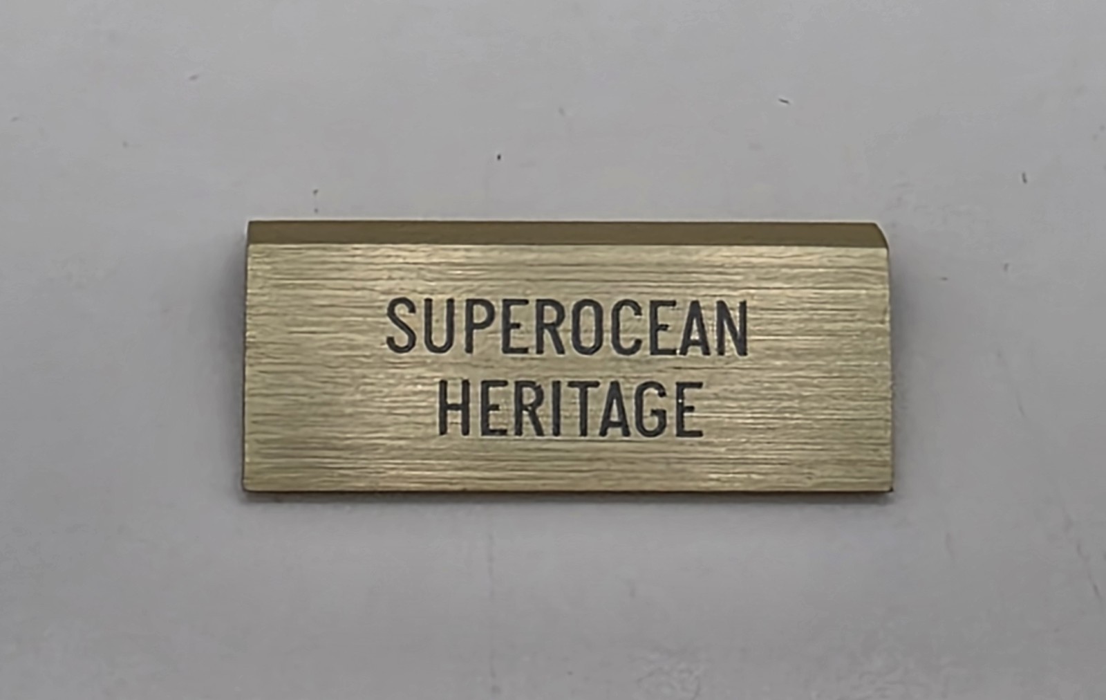 ORIGINAL OMEGA “SUPEROCEAN HERITAGE” SMALL DEALER’S BRASS PLAQUE PRE-OWNED