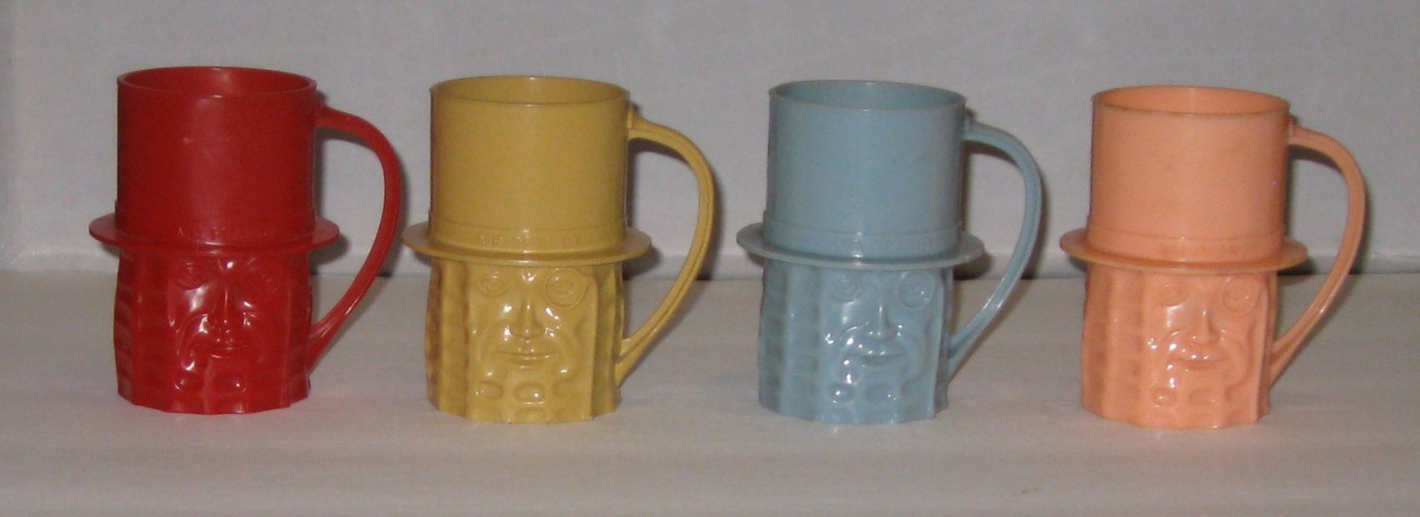 LOT OF 4 VINTAGE PLANTERS MR PEANUT CUPS/ MUGS – RED, TAN, BLUE & PINK – 1950s