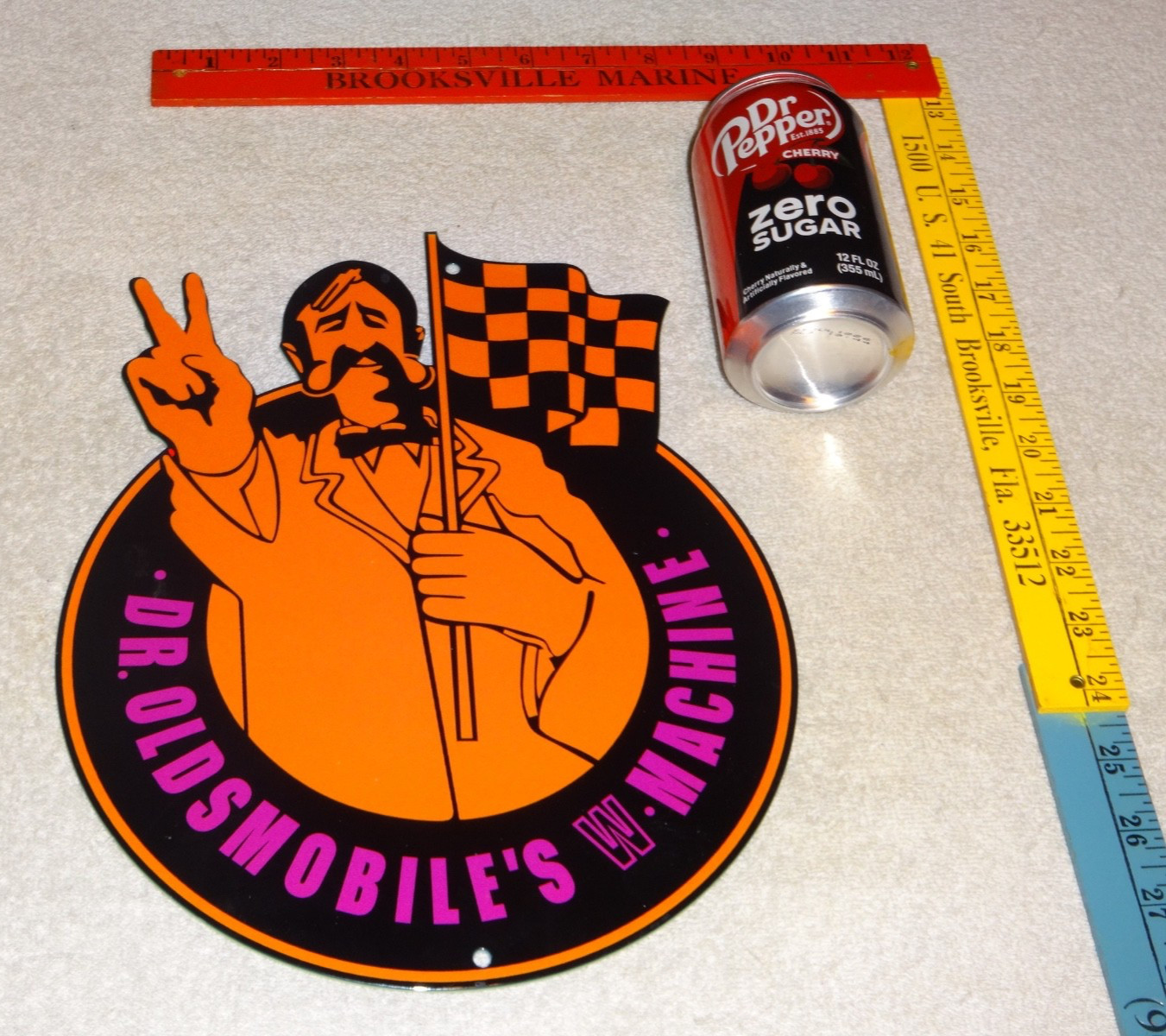 VINTAGE DR. OLDSMOBILE MUSCLE CAR MACHINE MAN 12″ ENAMEL METAL GASOLINE OIL SIGN
