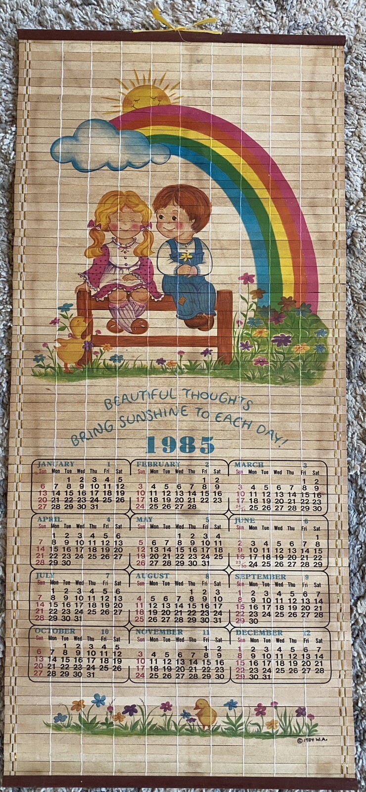Bamboo Roll Up Hanging 1985 Calendar with a Girl Boy and Rainbow Vintage