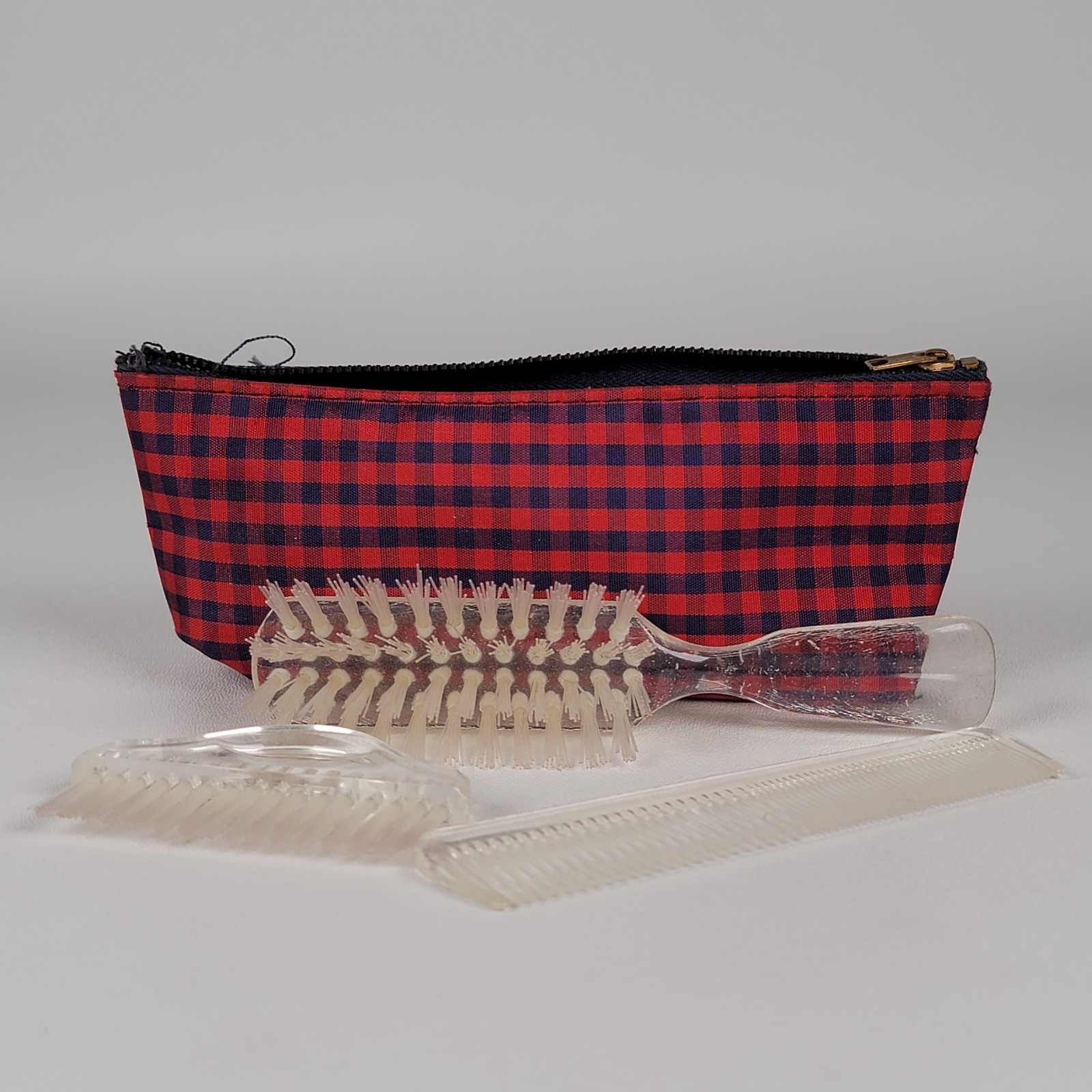 vintage-style hair care set containing a hairbrush, a smaller hand or nail brush