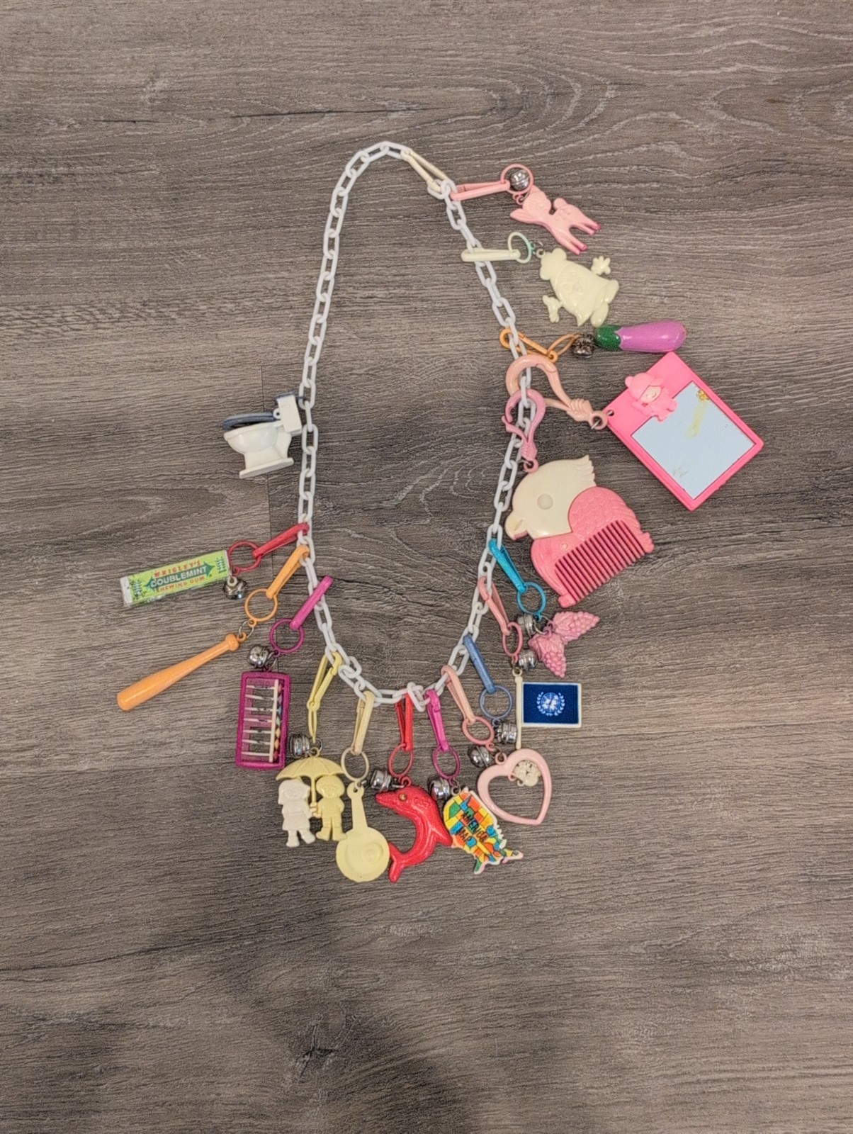 Vintage Plastic Bell Clip On 1980s Charm Necklace with 17 Charms